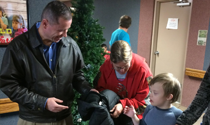 EUCCU's president giving a coat to a student at the Castle Valley Center.