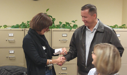 EUCCU's president giving a check to purchase new IPads.